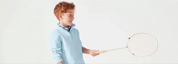 Boy wearing a light blue quarter-zip pullover.