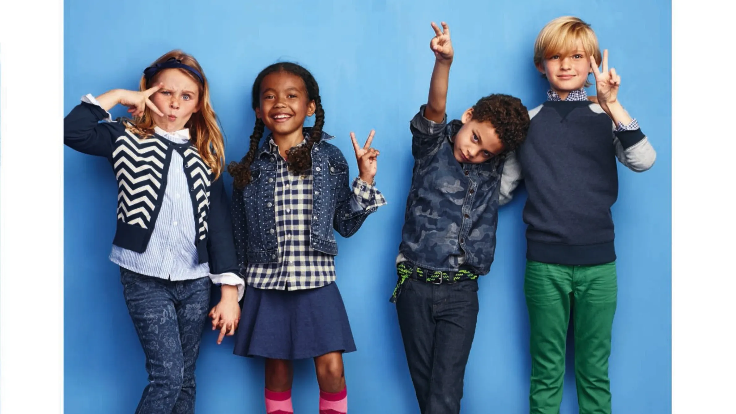 Four kids wearing Lands' End kids' clothing.