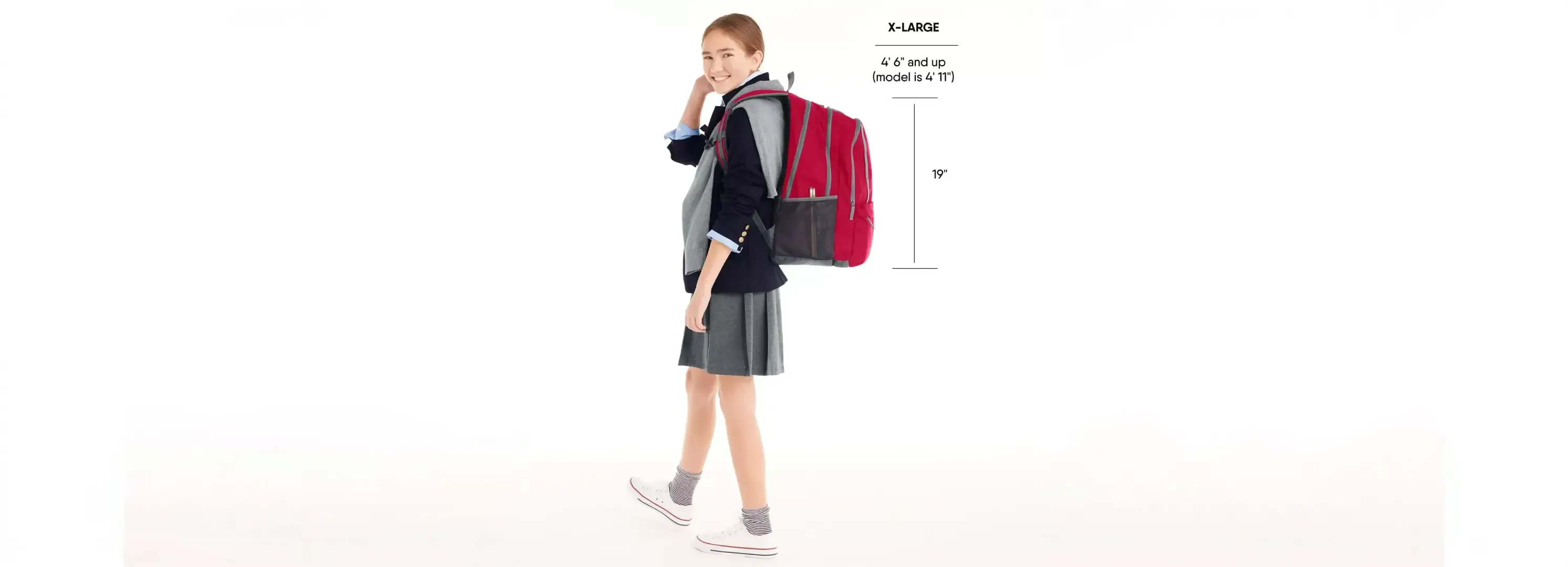 Girl wearing a red backpack and school uniform.