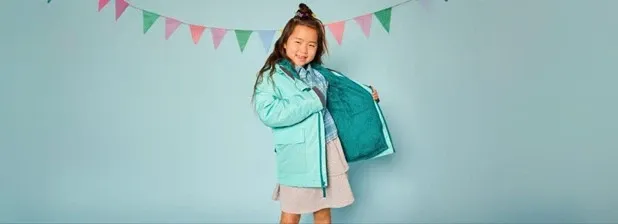 Girl wearing a teal water resistant insulated jacket.