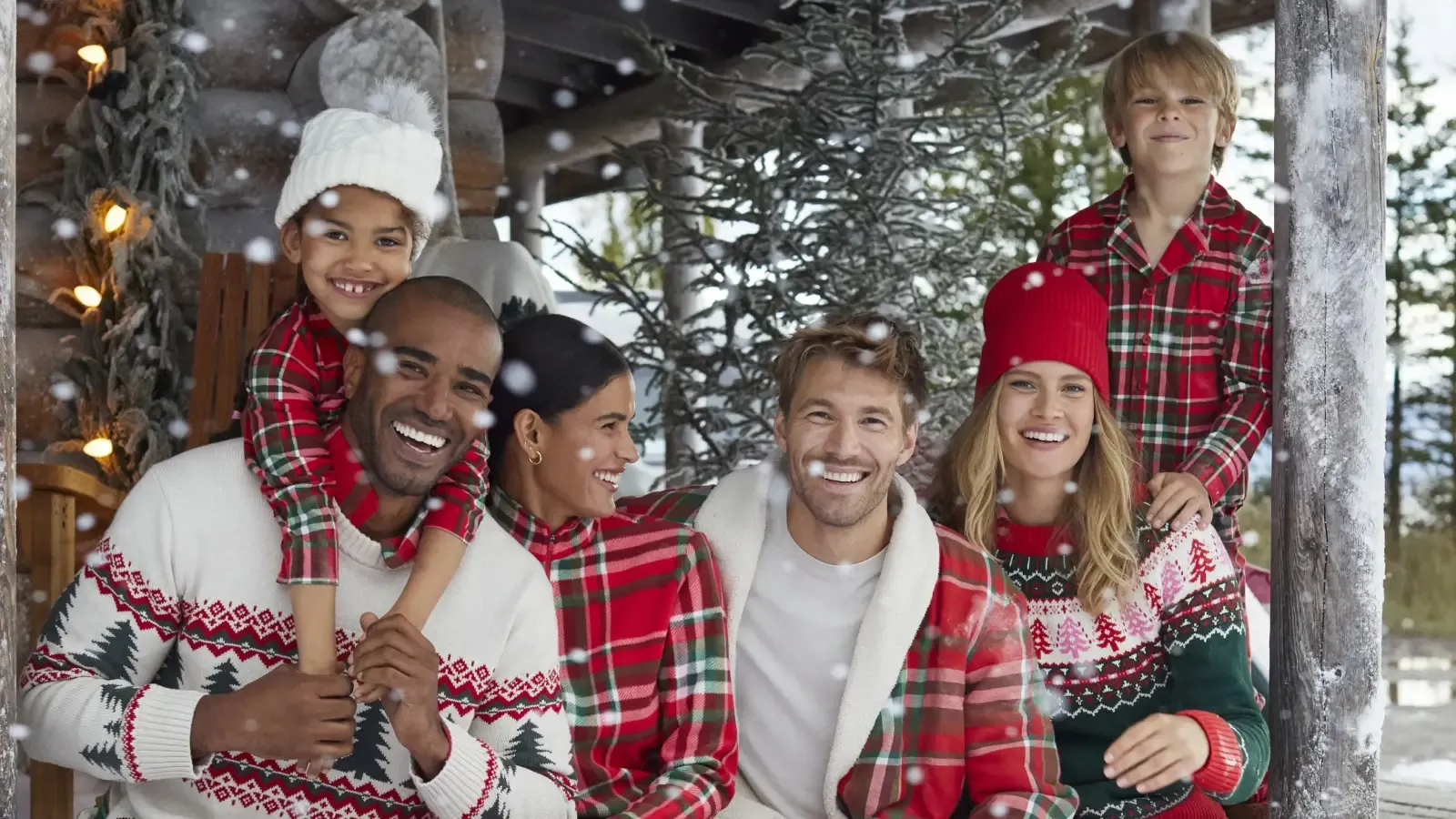 A group of friends wearing coordinated Christmas outfits gathered for a picture.