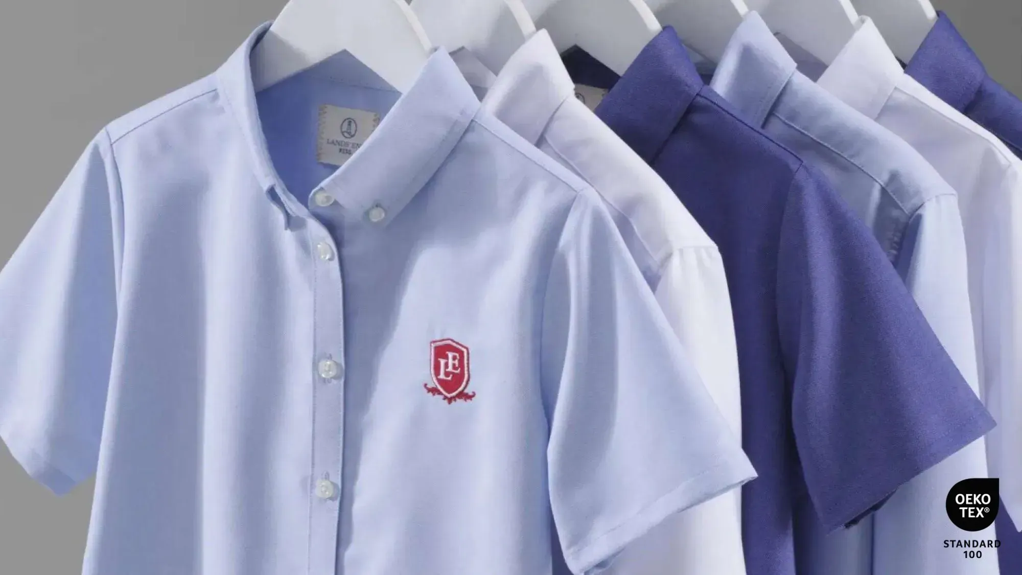 Several Lands' End school uniform shirts on hangers.