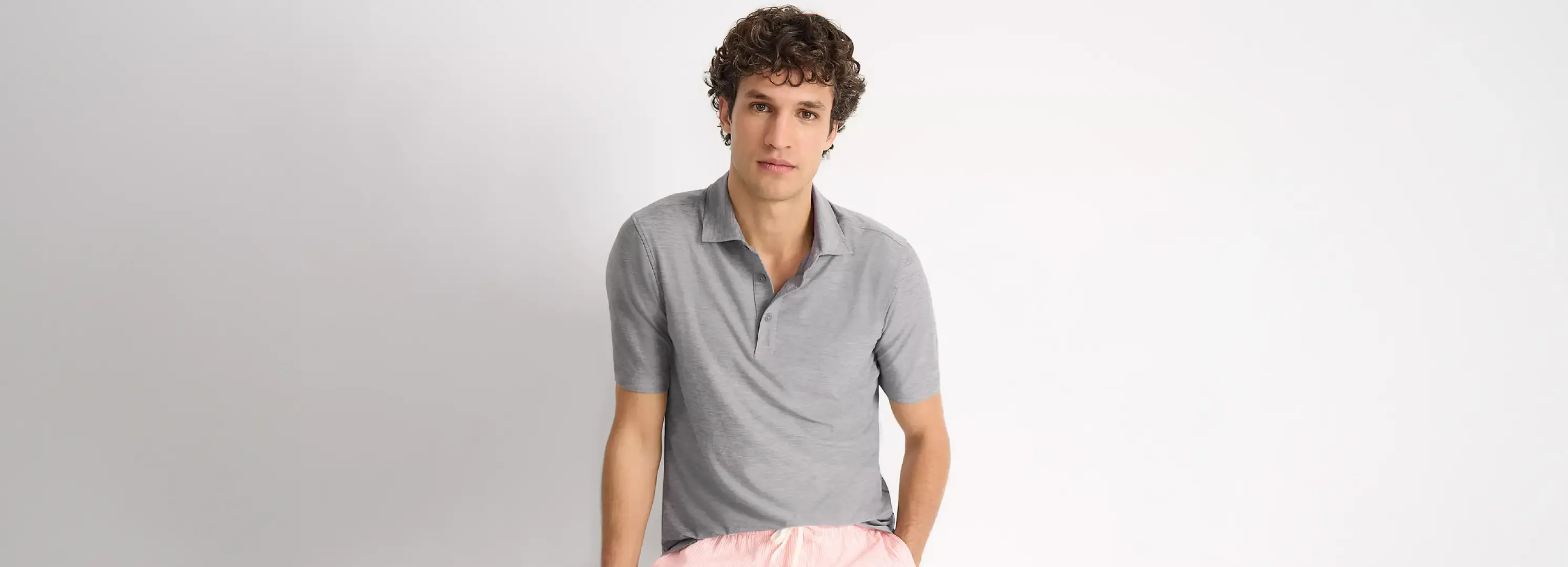 Man wearing a gray polo shirt.