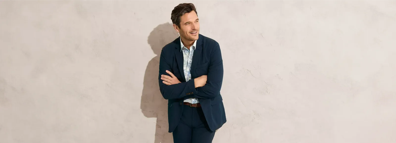 Man wearing a navy-blue suit with a white dress shirt.