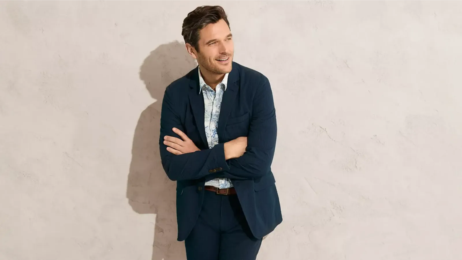 Man wearing a navy-blue suit with a white dress shirt.