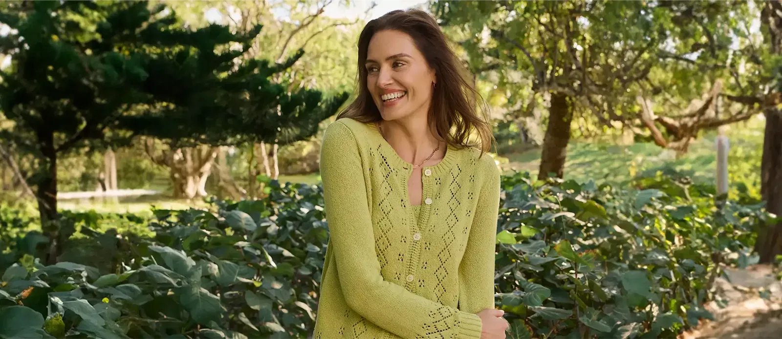 Women wearing a green cardigan sweater.