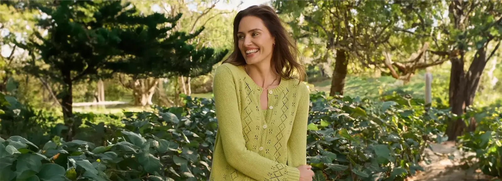 Women wearing a green cardigan sweater.
