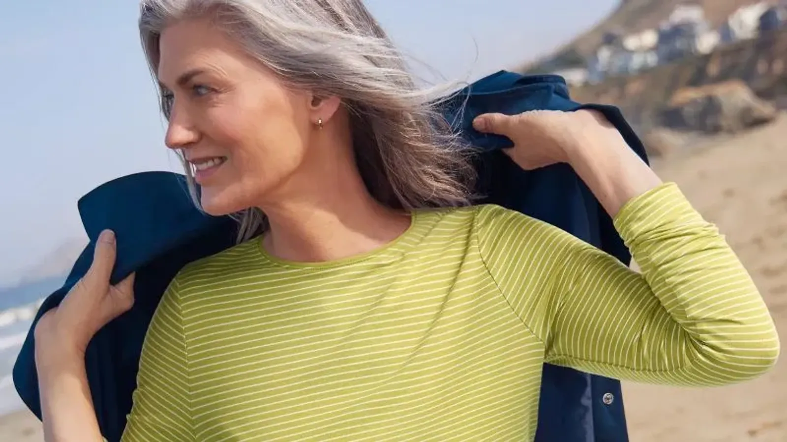 A woman wearing a green white striped shirt.