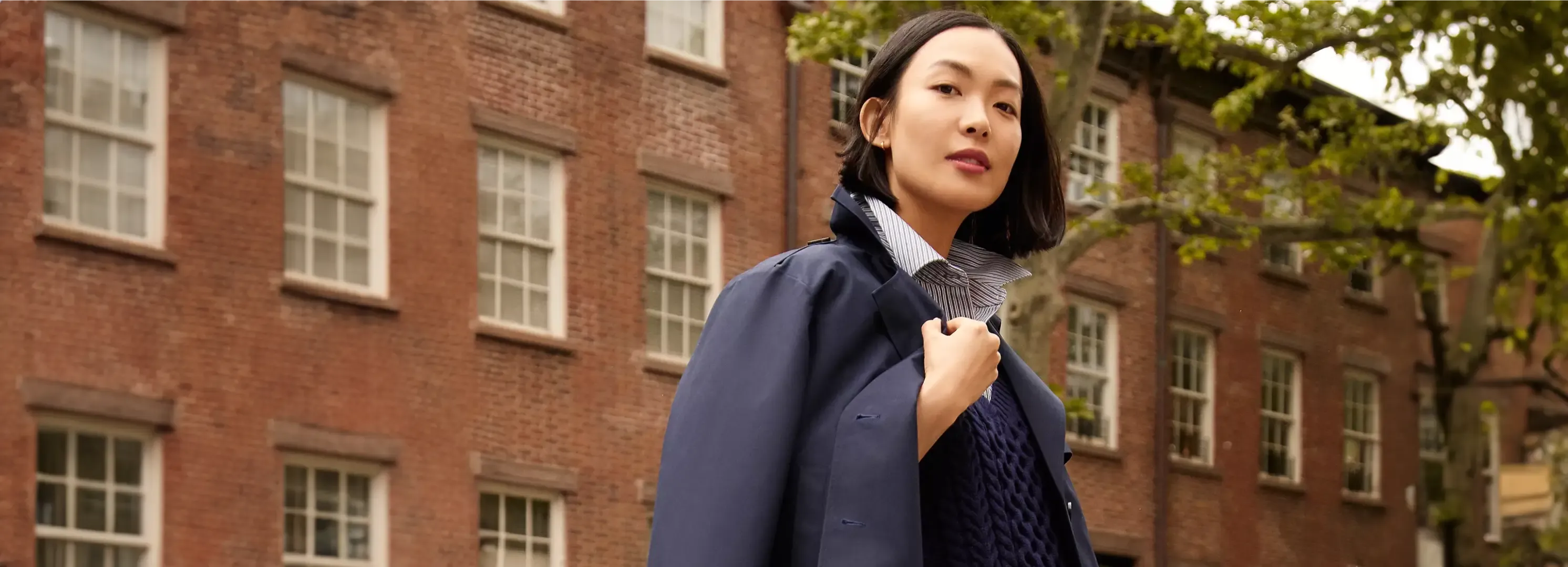 Woman wearing a navy jacket.