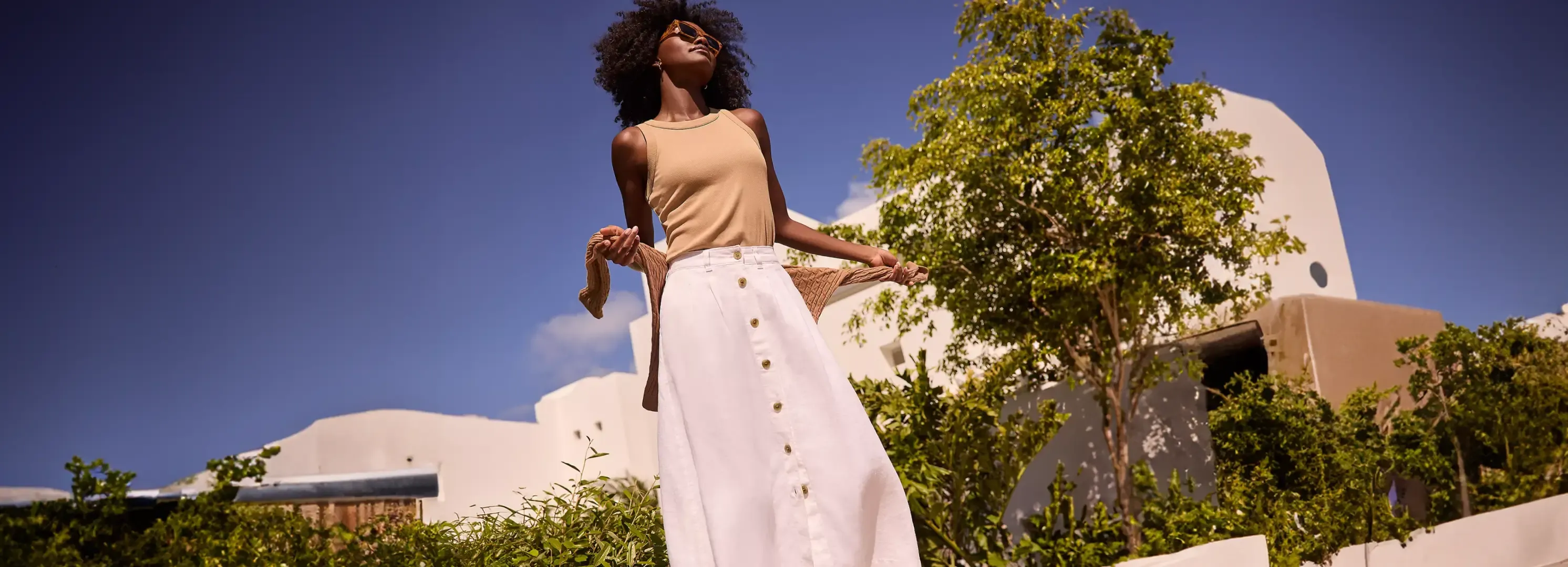 Woman wearing Tan Tank Top and Linen Skirt.