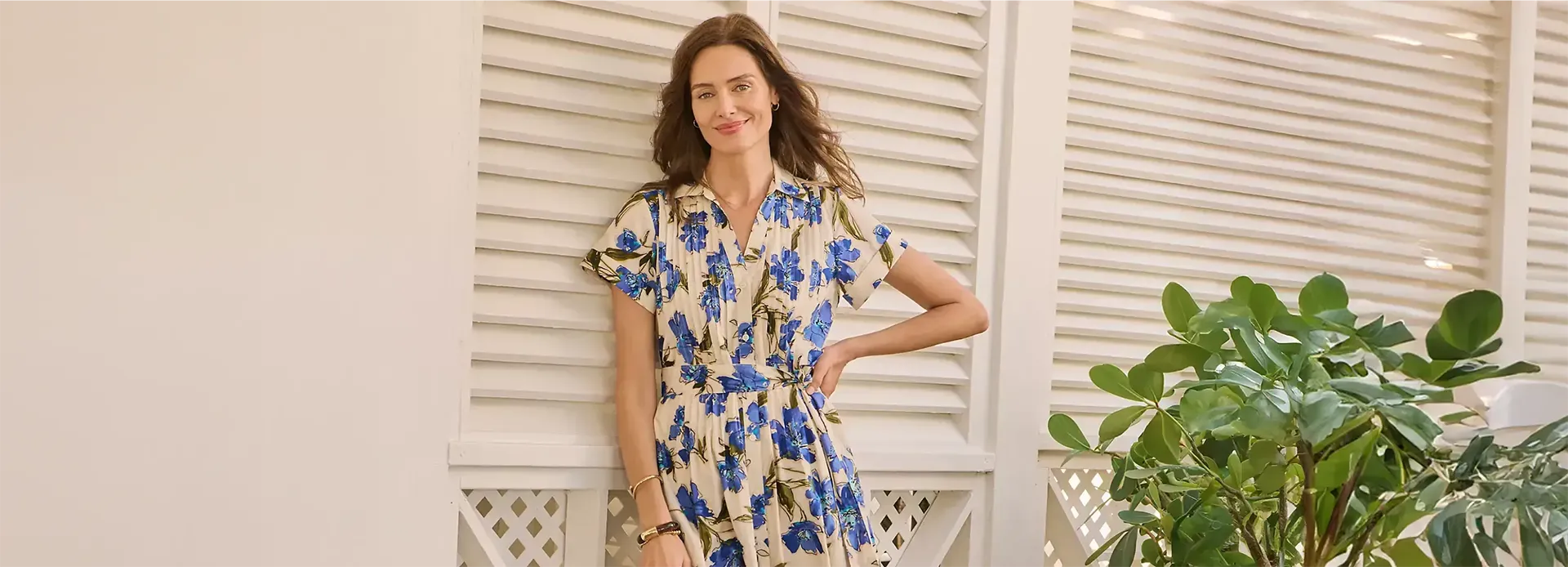Woman wearing a white and blue floral summer dress.