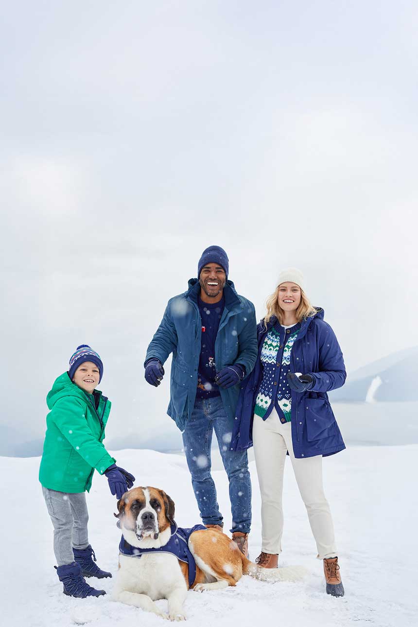 Family wearing coats, sweaters, pants and hats