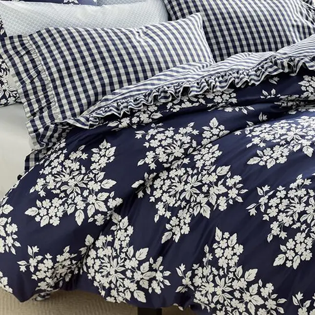 Navy bedding with white floral pattern.