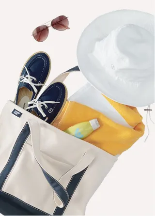 A canvas tote holding shoes, a hat, sunglasses, a bottle of lotion, and other items.