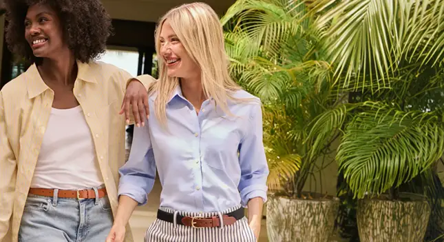 Two women wearing buttondown no iron shirts.