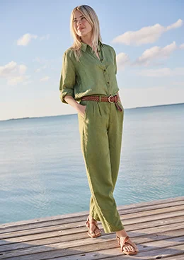 A woman wearing a white sleeveless top and shorts.