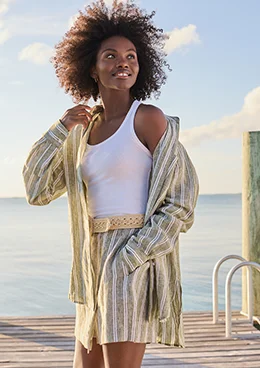 A woman wearing a green linen top.