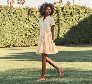 A woman wearing a yellow linen dress.