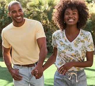 A man and a woman holding hands outdoors.