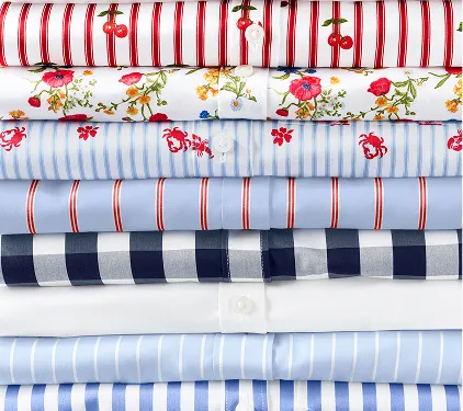 A folded stack of no iron shirts.