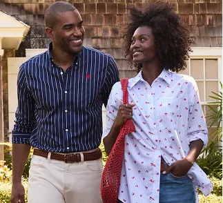 A man wearing a blue and white striped top and a woman with a white top with a cherry pattern.
