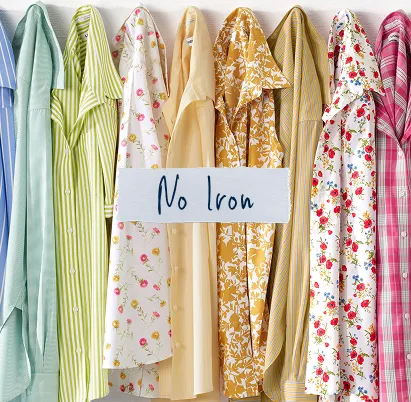 Torn paper that is labeled: No Iron. Several hung patterned shirts.