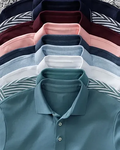 A stack of supima polos in different colors and patterns.