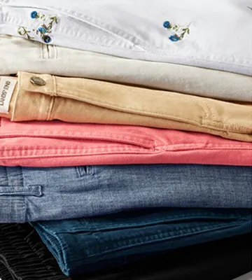 A folded stack of pants and shorts.