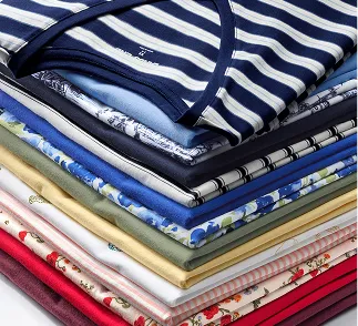 A stack of folded tops in different colors and patterns.