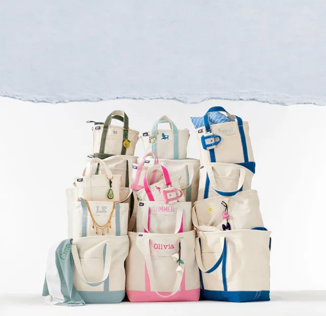 Canvas totes in assorted colors with monograms and accessories.