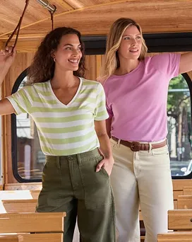 Two women wearing supima tops stand next to each other.