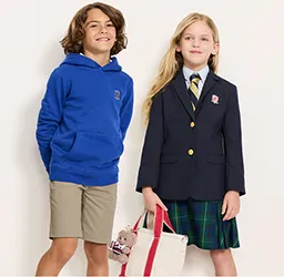 A boy wearing a blue hoodie and a girl wearing a uniform jacket and skirt.