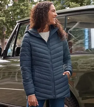 A woman wearing a navy Wanderweight jacket.