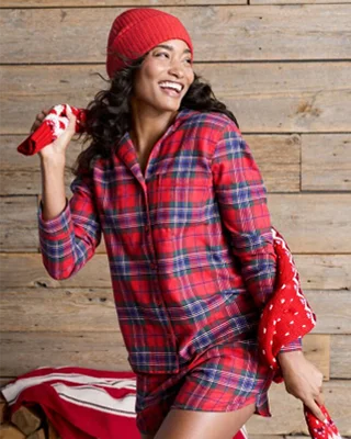 A woman wearing flannel pajamas.