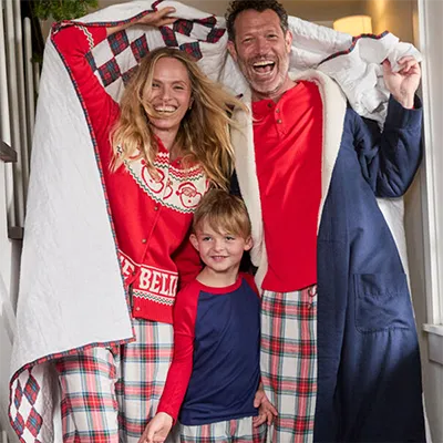 A family wearing holiday pajamas.