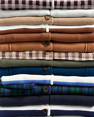 A stack of cardigans in different colors and patterns.