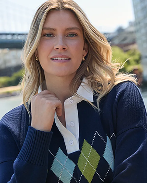 A woman wearing an argyle pattern sweater.