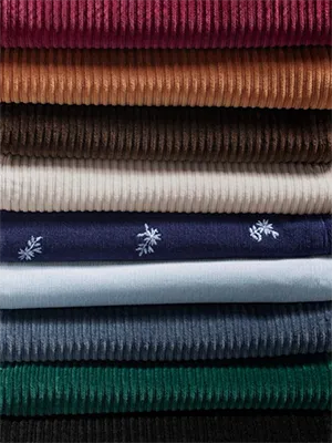 A stack of corduroy in different colors.