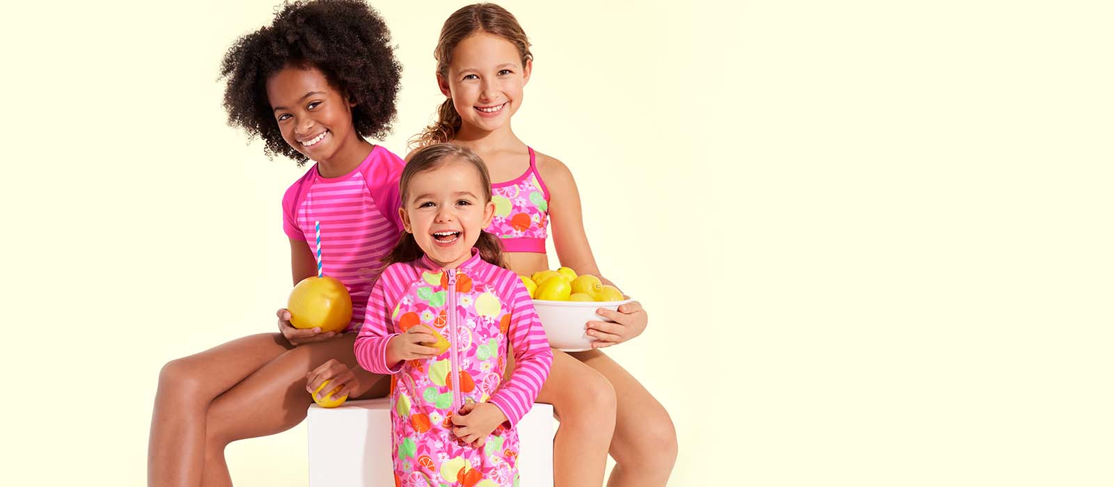 Three girls in pink swimsuits