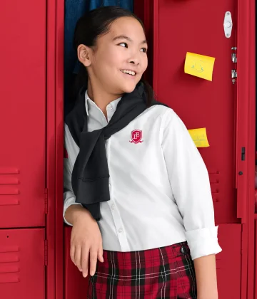 A girl wearing a dress shirt and a skirt.