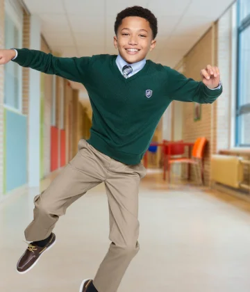 A boy wearing a sweater and pants.