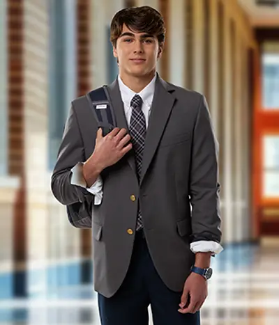 A student wearing a gray sports coat with a backpack.