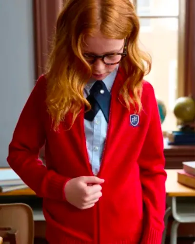 A student zipping up a red sweater.