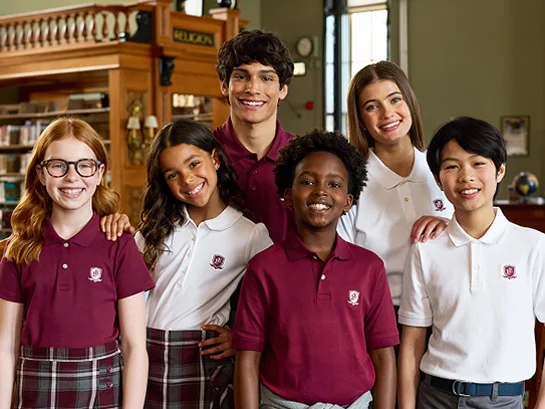 A group of students wearing red and white school uniform polos