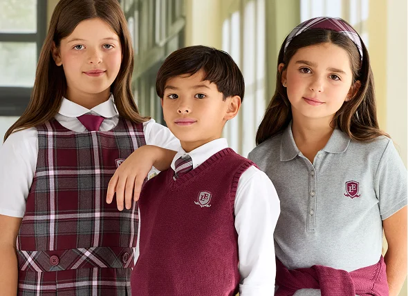 Students wearing school uniforms in burgundy, white and gray